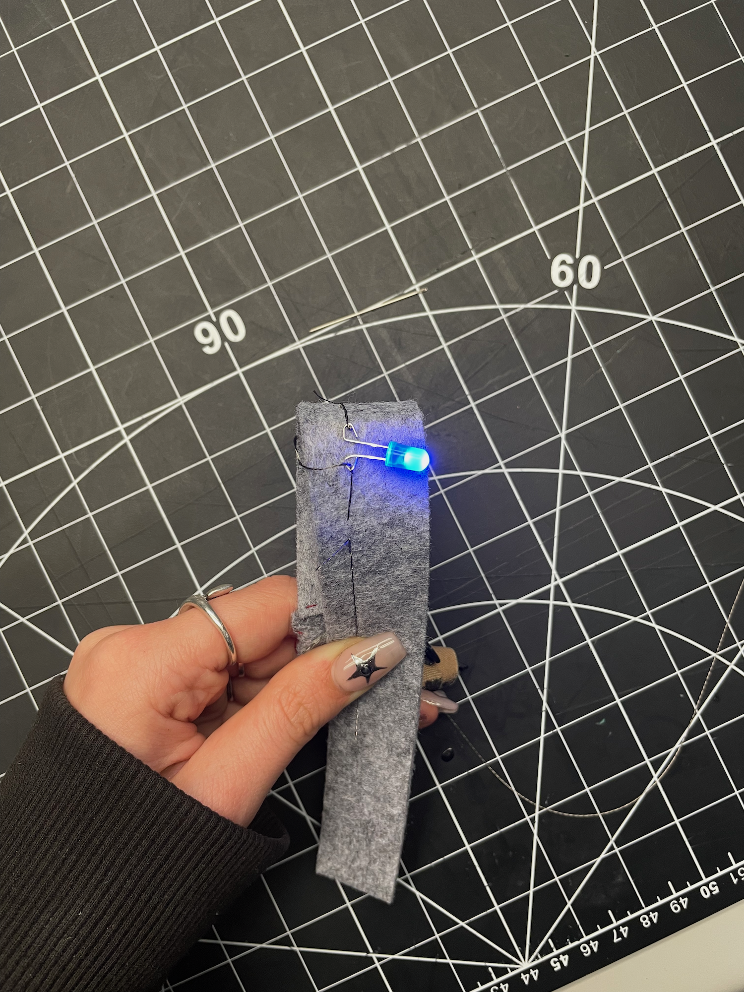 My second last and favourite creation from this activity crates a circuit through conductive 
                  thread and a hole in the insulative felt. I was devistated at first because the circuit was not
                  working but switching which sides the thread were on the battery fixed this, reminding me on 
                  the importance of + and -. I wonder if other people faced this dilemma.